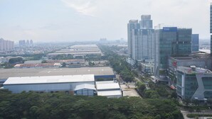 A cityscape with modern high-rise buildings, industrial areas, and green spaces. - Cozy Stay And Homey Studio At Tifolia Apartment (Jakarta)