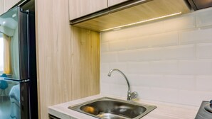 Deluxe Apartment | Private kitchen - Homey And Cozy Living Studio Apartment At B Residence (Pagedangan)