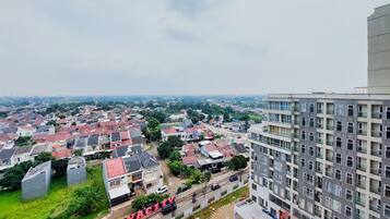 A residential area with a mix of houses and a large building with balconies.