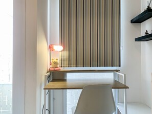 Work in comfort with a desk and chair, plus ample natural light from the large window.
