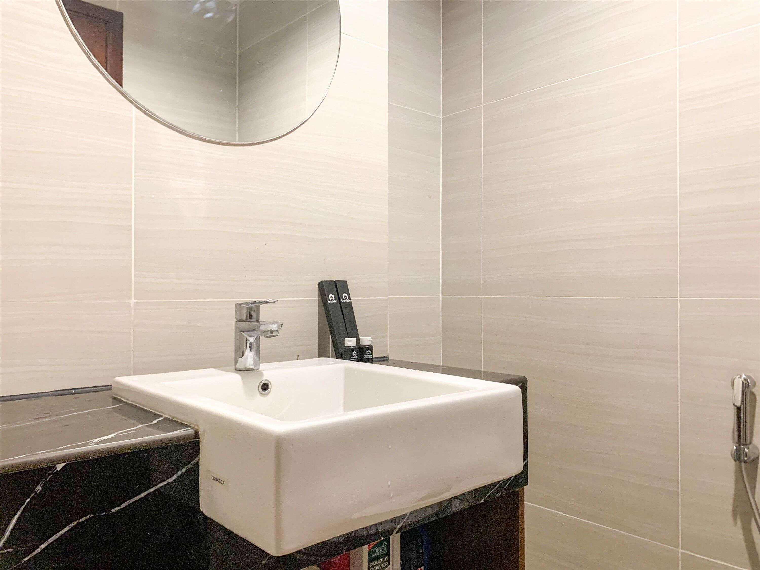 A bathroom with a white sink, a mirror, and a shower.