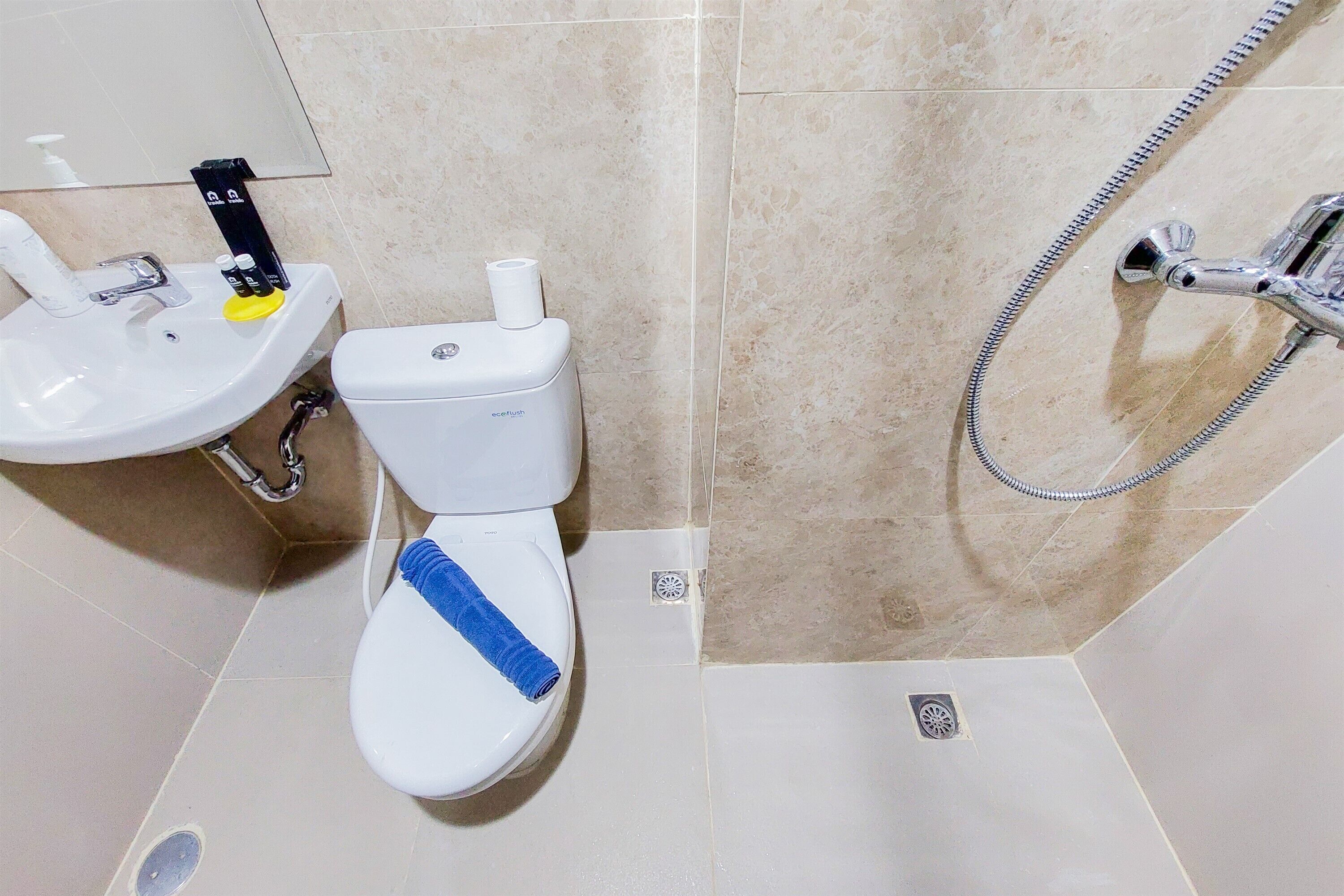 A bathroom with a toilet, sink, and shower.