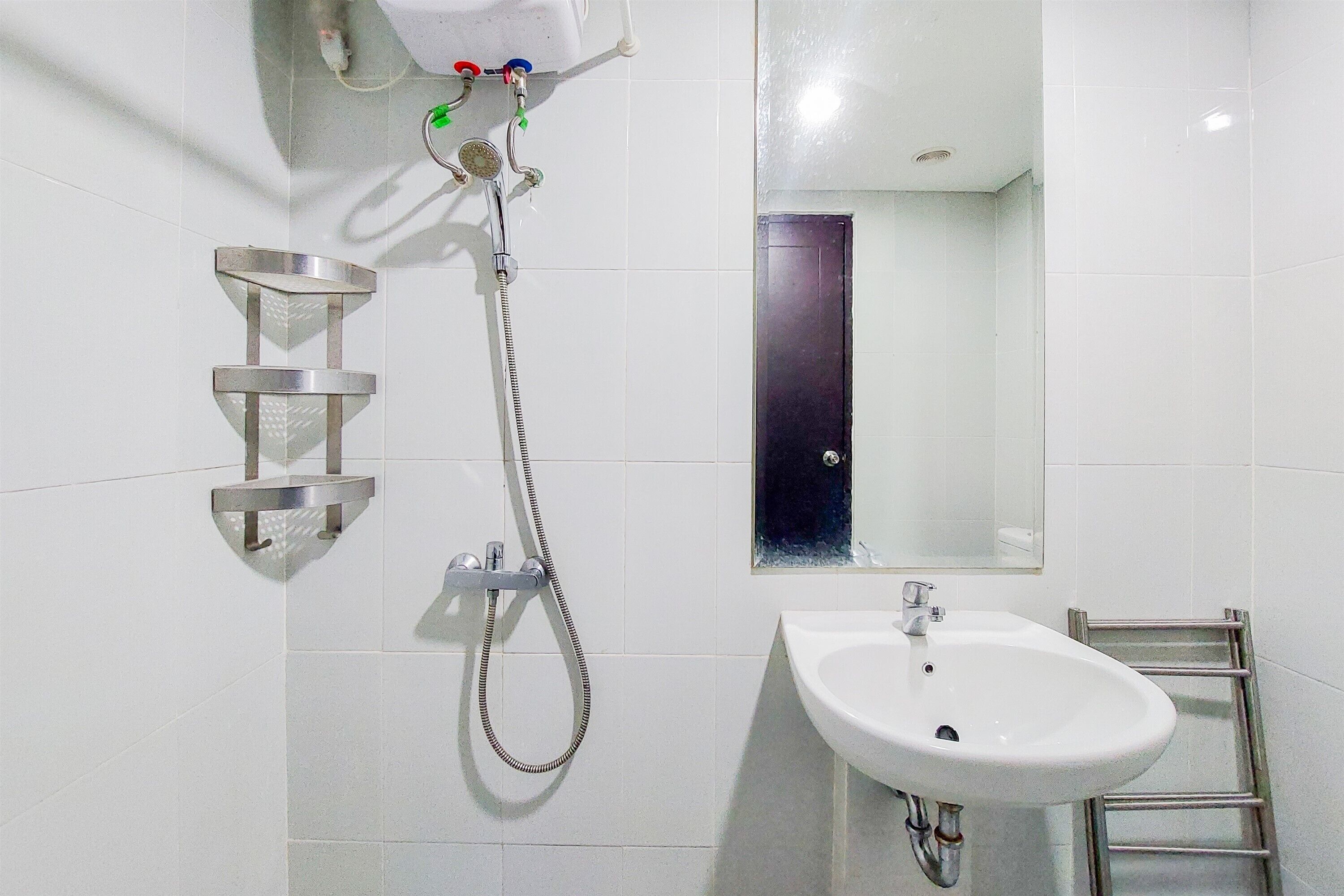A bathroom with a shower, a sink, and a mirror.