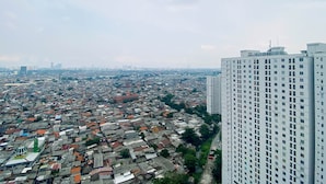 A high-rise building with a dense urban area in the background.