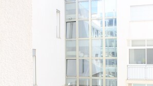 A modern building with large glass windows and a balcony. - Virgilio 82 - Penthouse With Terrace (Trapani)