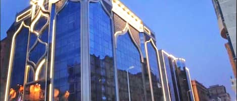 A modern building with a glass facade and illuminated architectural details.