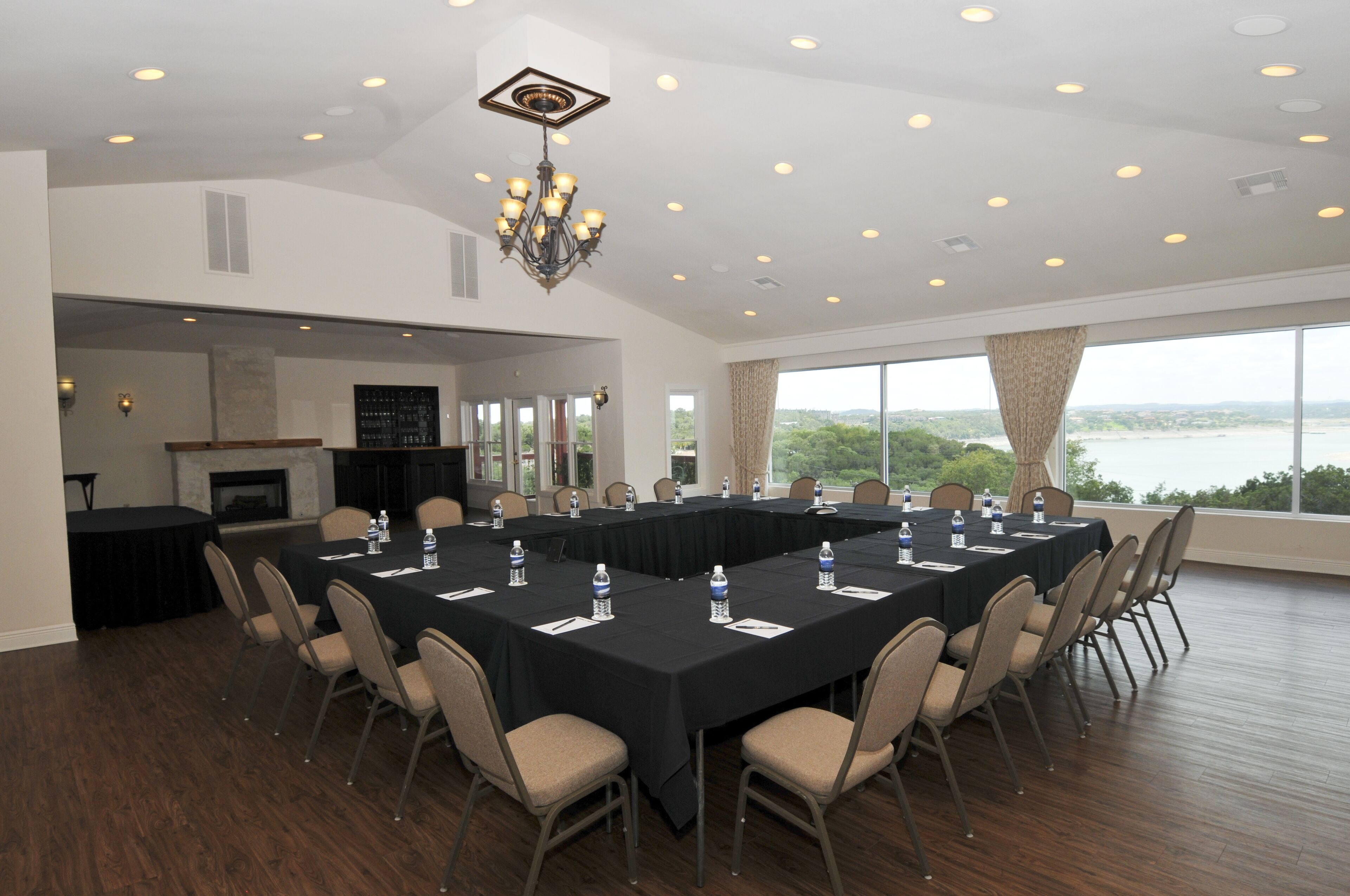 A conference room with a long table, chairs, and a chandelier.