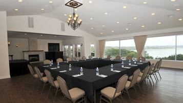 A conference room with a long table, chairs, and a chandelier.