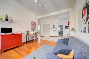 A modern living room with a red dresser, a grey sofa, and a television. - Casa Rachele Stresa Center (Stresa)