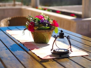 A rustic wooden table with a potted plant and a vintage lantern. - Villa Antonija - Four-bedroom Villa With Terrace and Private Pool (Konavle)