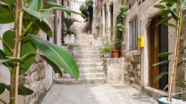 A narrow stone pathway leading up a set of stairs in a historic building.