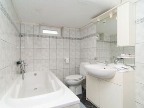 A bathroom with a bathtub, toilet, and sink. - Apartments Roko - Standard One Bedroom Apartment With Shared Terrace (Dugi Rat)