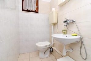 A small, clean bathroom with a toilet, sink, and shower. - Apartment Dalmatin Zuljana - Two-bedroom Apartment 2 (Ston)