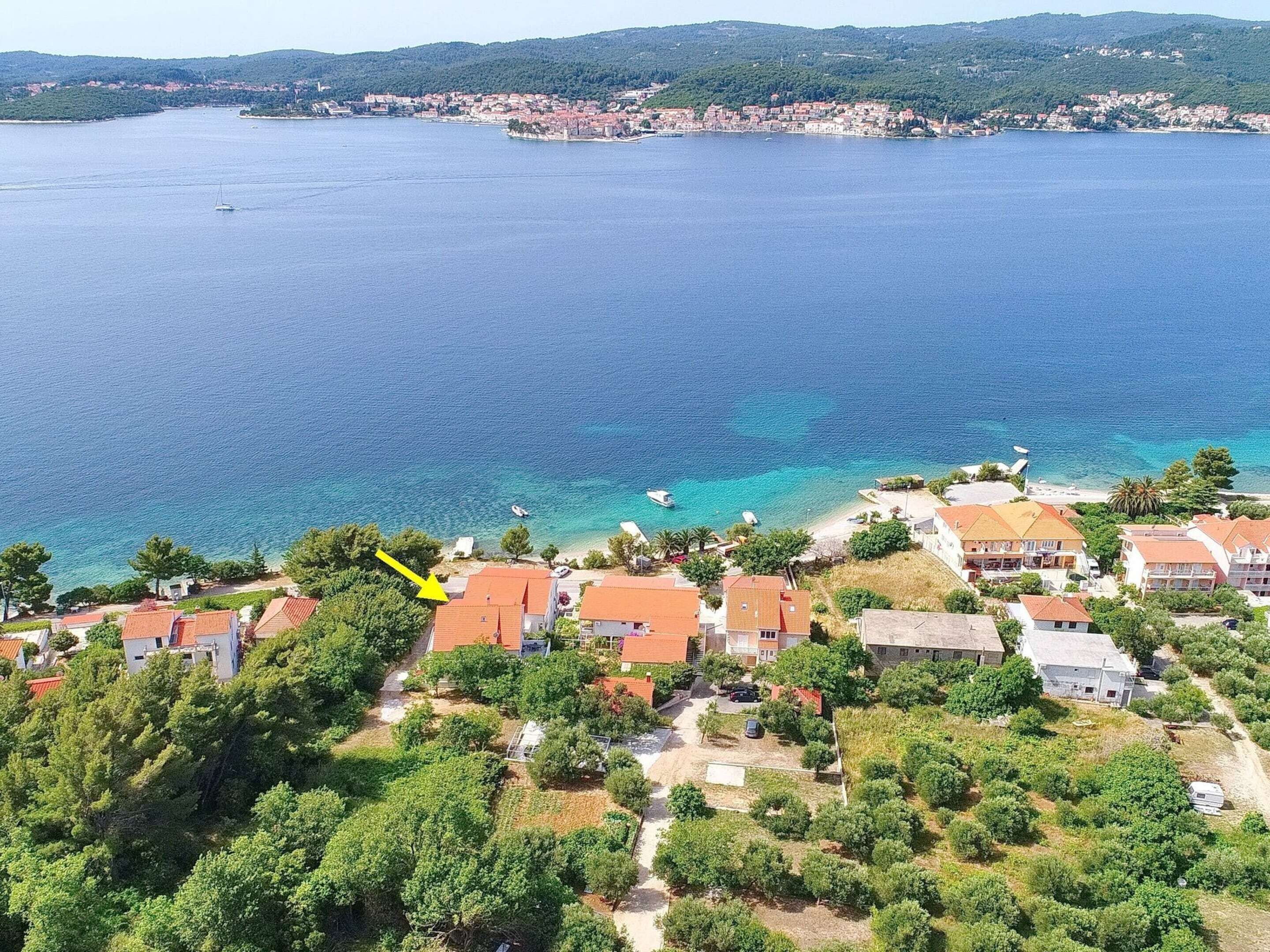 A coastal village with houses and a clear view of the sea.