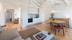 A modern apartment with an open-plan kitchen, dining area, and living space.