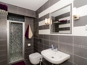 A modern bathroom with a shower, toilet, and sink. - Apartments Gaura - Comfort One-bedroom Apartment With Terrace (Dubrovnik)