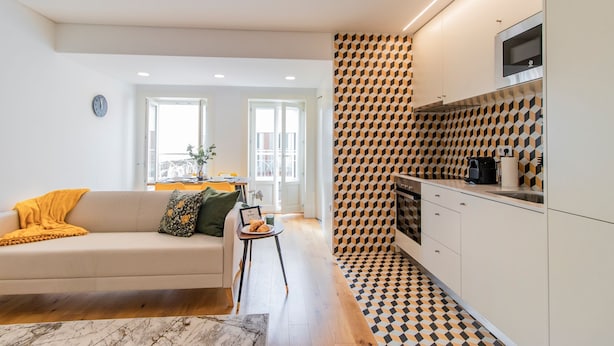 Un appartamento moderno con soggiorno, angolo cottura e zona pranzo.