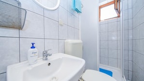 A bathroom with a white sink, a toilet, and a shower area. - Apartments Filipovic - One Bedroom Apartment With Terrace and Sea View (Mljet)