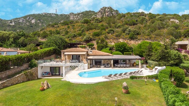 A villa with a swimming pool, outdoor seating, and a view of the surrounding hills. - Luxe Cote Stay- Elegant Villa (Arzachena)