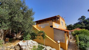 A yellow building with a tiled roof, a staircase leading to a covered area, and a sign indicating 'SOBRA 41'. - Apartments Vinko Mljet- One-bedroom Apartment With Terrace (Mljet)