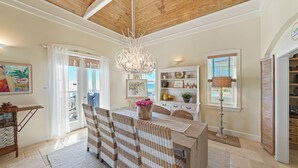 A spacious kitchen with a central island, wooden ceiling, and a chandelier. - Stunning Gulf Front! Private Pool & Beach Access | Inquire for Specials! (Miramar Beach)