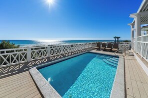 A clear blue pool with a wooden deck and white railings, overlooking a beach and ocean. - Stunning Gulf Front! Private Pool & Beach Access | Inquire for Specials! (Miramar Beach)