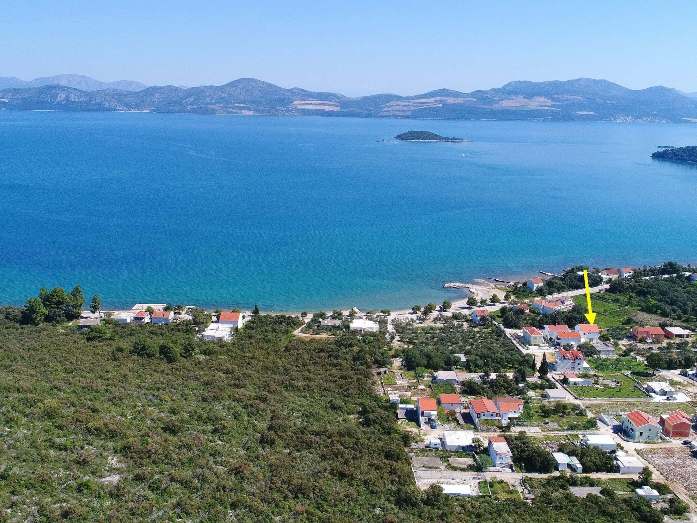 A coastal village with houses and a beach.