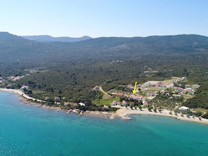 An aerial view of a coastal town with a beach, houses, and a forested area. - Apartments Lemes - Studio Apartment With Terrace Ap 2 (Janjina)