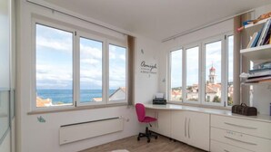 A room with large windows, a desk, a chair, and a radiator. - Apartment Marcela - Deluxe Two Bedroom Apartment With Terrace and Sea View (Sutivan)