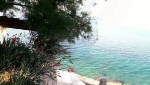 A coastal view with a stone pathway leading to a terrace overlooking the sea. - Holiday Home Luna - Two Bedroom Holiday Home With Sea View (Korcula)