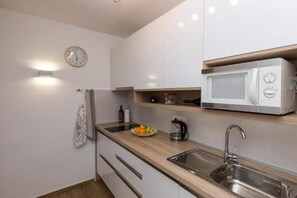 Apartment | Private kitchen | Fridge, microwave, stovetop, dishwasher