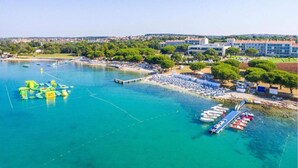 A coastal area with a marina, beach, and buildings. - Apartment in Liznjan With Pool and Terrace (Liznjan)