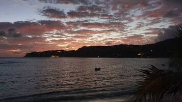 Experience the serene tranquility of a peaceful beach at sunset.