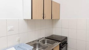A kitchen with white cabinets, a stainless steel sink, and a dishwasher. - Apartments Felix Mljet - One Bedroom Apartment With Balcony (Mljet)