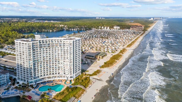 A high-rise hotel with a pool, beachfront, and ocean view. - Oceanfront Winter Escape- Ask About Monthly Discounts – Heated Pools/Spas/Views (Myrtle Beach)