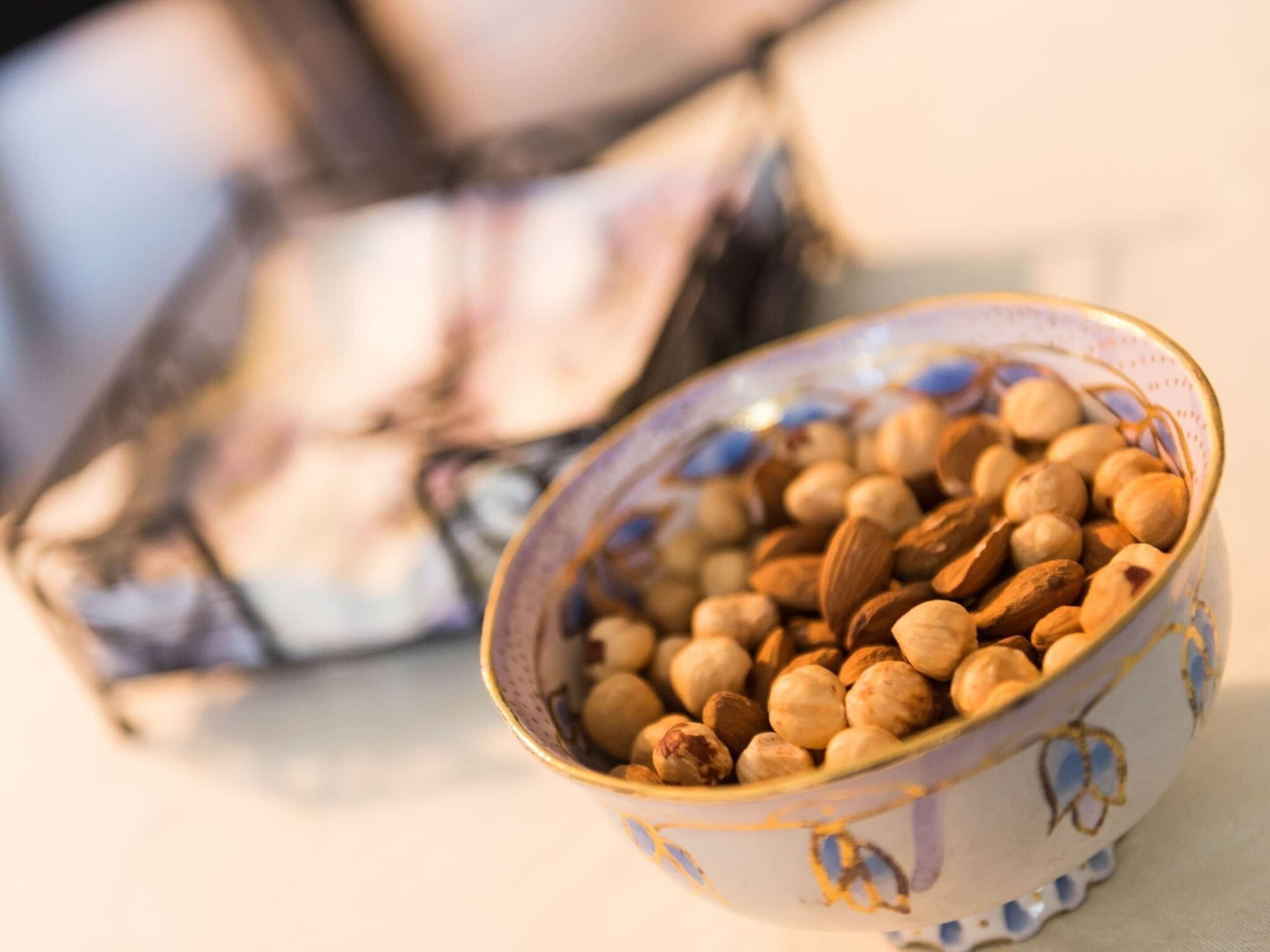 A bowl of mixed nuts on a table.