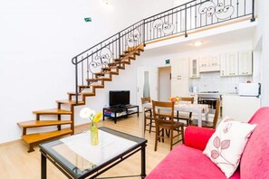 A living room with a staircase, a dining area, and a kitchen. - Apartments Nikola - Superior One Bedroom Apartment With Sea View (Dubrovnik)