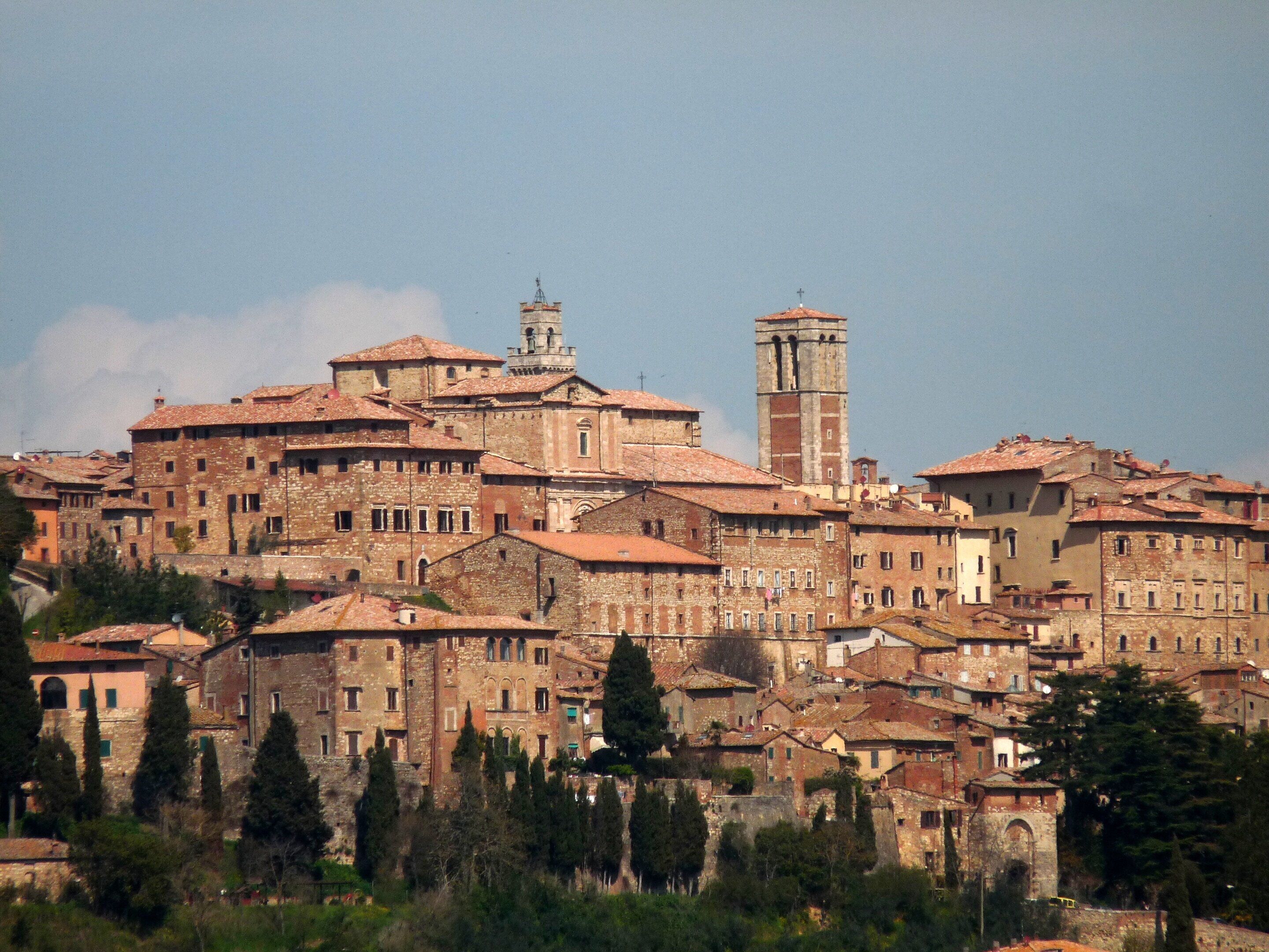 A historic town with medieval architecture, including a prominent church tower and a fortified building.