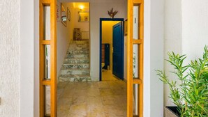 A hallway with marble stairs leading to a room with a blue door. - Villa Piano - Four Bedroom Villa With Terrace and Swimming Pool (Zupa dubrovacka)