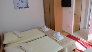 A room with two beds, a TV mounted on the wall, and a wooden wardrobe. - Apartments Franka - Studio With Terrace and Sea View (Dubrovnik)