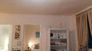 A room with a white cabinet, a bed, and a window with curtains. - Apartments Mediterranean House - Two Bedroom Apartment With Terrace (Slivno)
