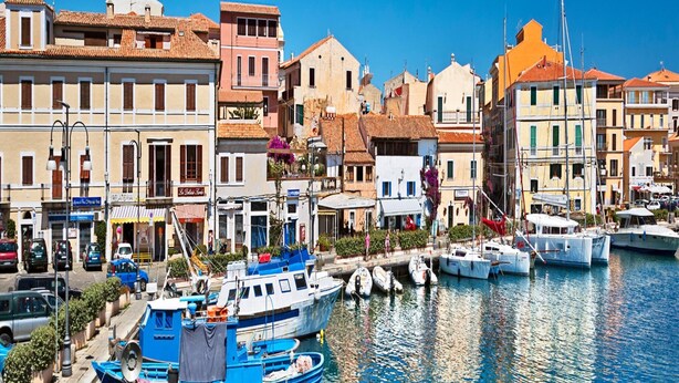 A coastal town with colorful buildings, a marina with boats, and a clear blue sky. - Apartment in Olbia With Garden (Olbia)