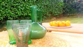 A table with green glassware and a woven placemat.