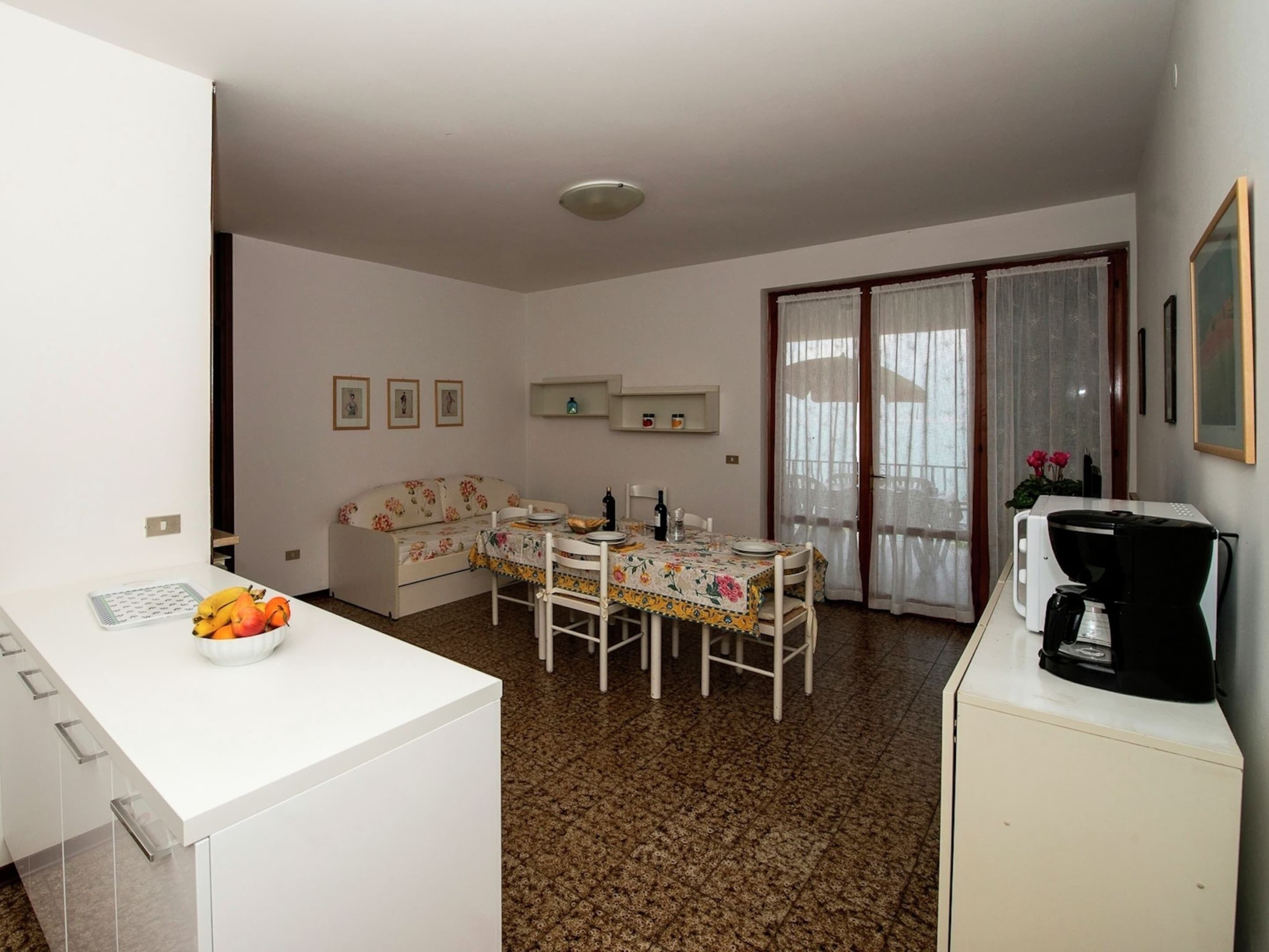 A compact living space with a kitchenette, dining area, and a small seating area.