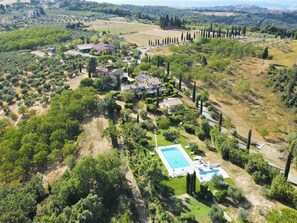 An aerial view of a property with a swimming pool, multiple houses, and surrounding greenery. - Romantic Escape in Tuscan (Gambassi Terme)