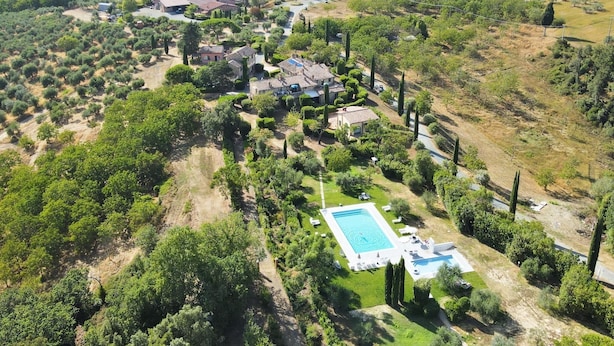 An aerial view of a property with a swimming pool, multiple houses, and surrounding greenery. - Tuscany Escape With Pool (Gambassi Terme)