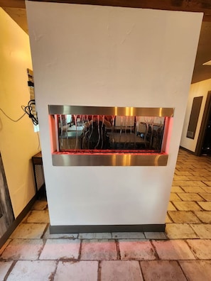 A modern kitchen with a built-in oven and a stainless steel backsplash.