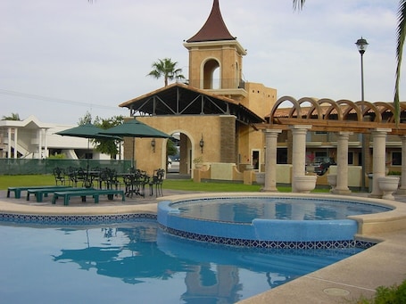 Outdoor pool, open 7:00 AM to 10:00 PM, pool umbrellas, sun loungers