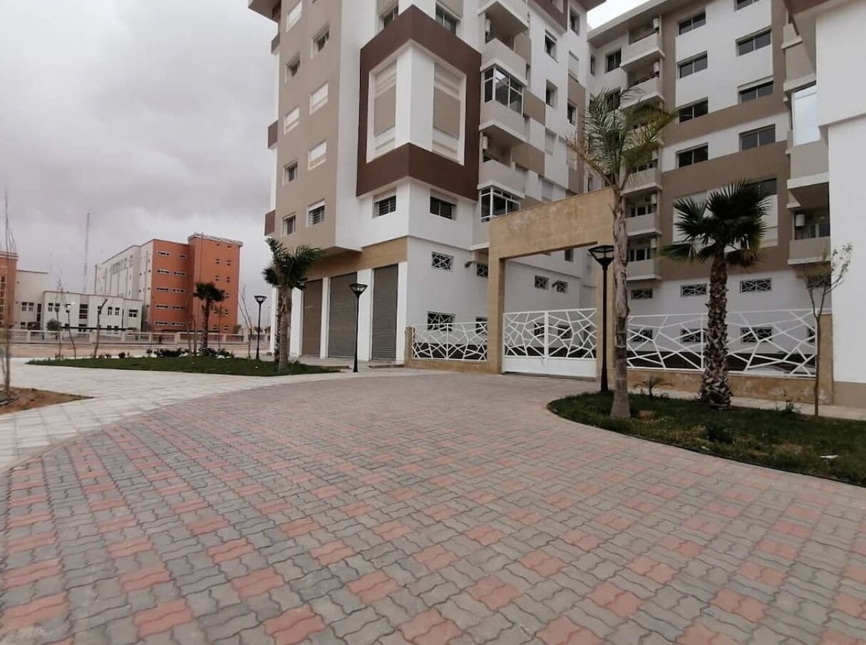 A multi-story residential building with a central courtyard.
