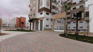 A multi-story residential building with a central courtyard.
